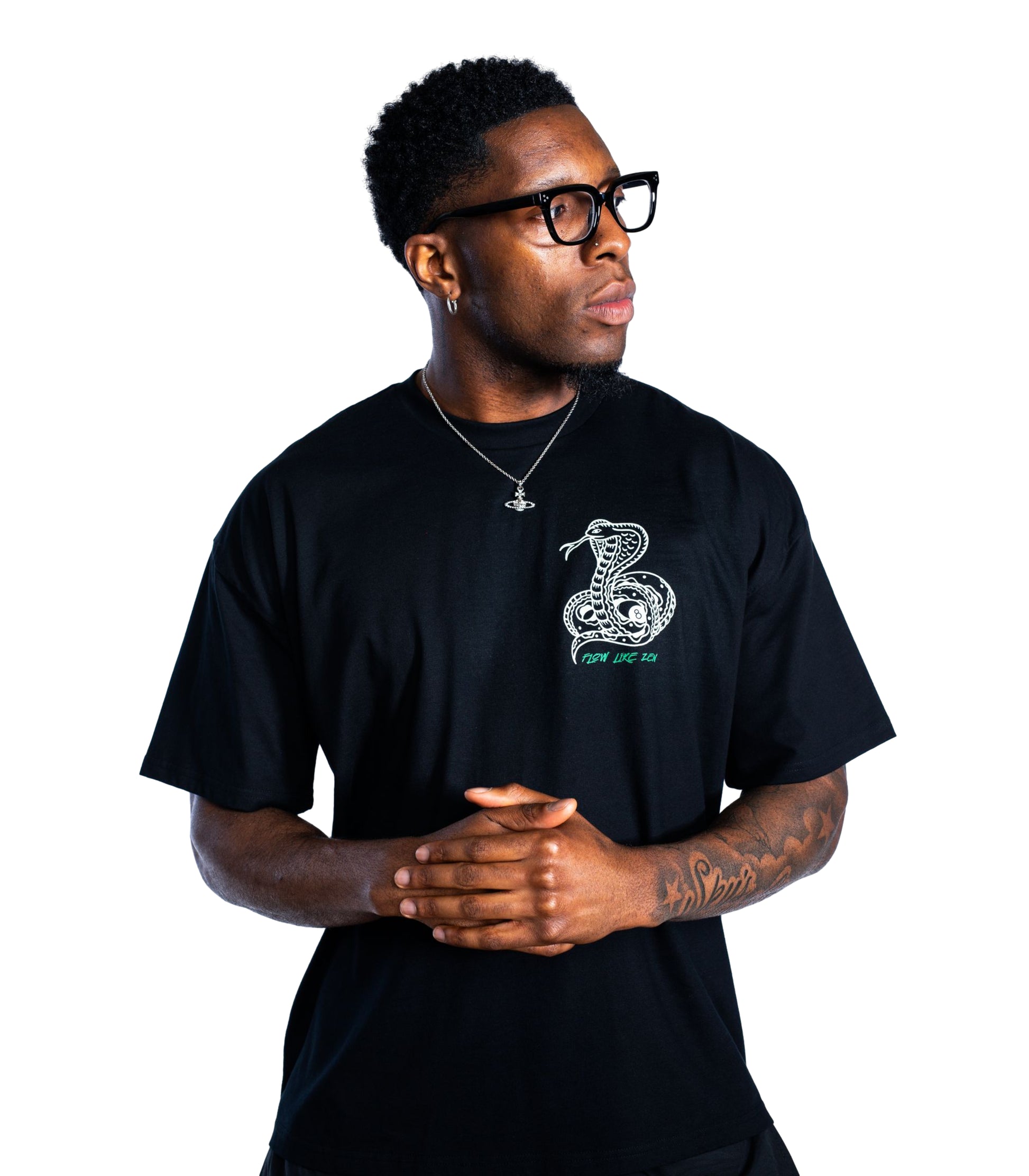 Man wearing a black t-shirt with a snake design on a white background