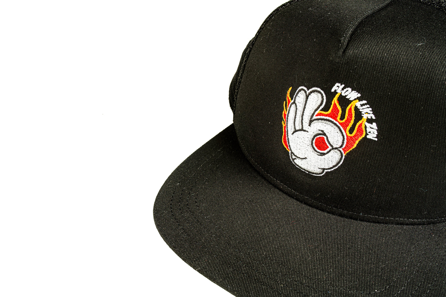 Black cap with logo on front of a hand wearing a white glove with flames in the background.