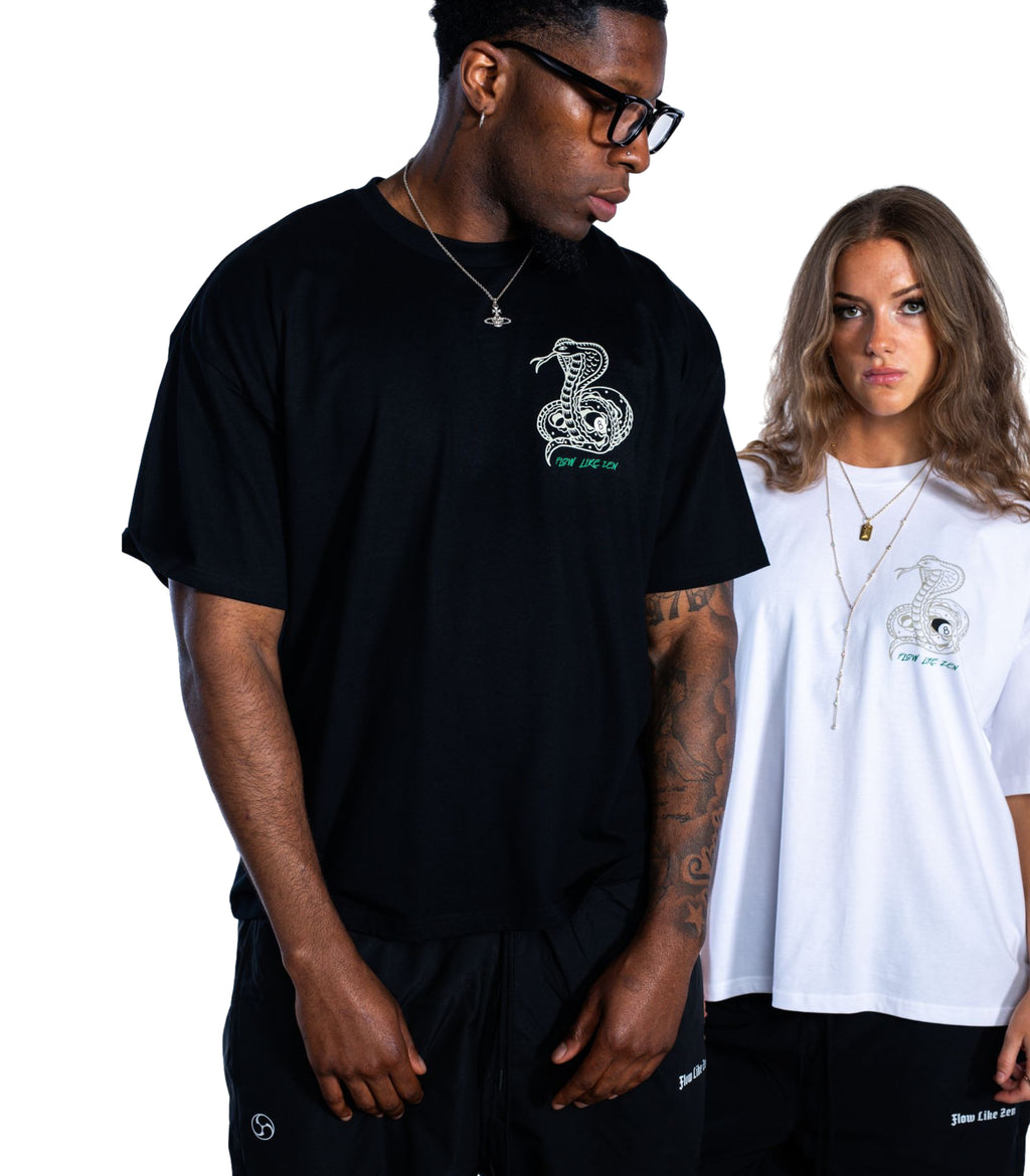 Two people wearing black and white t-shirts with a snake logo on a plain background
