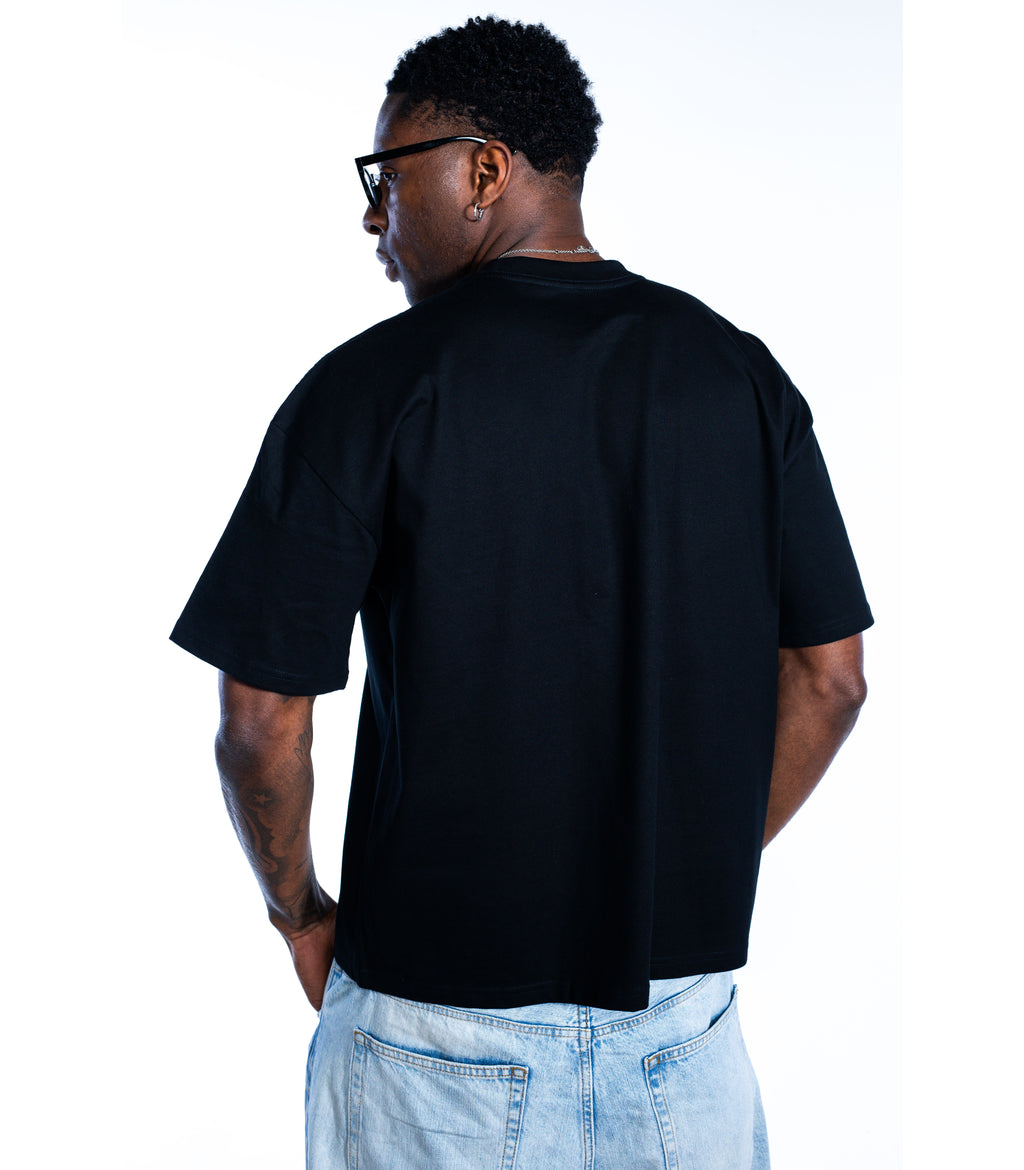 Back view of male model wearing Flow Like Zen black t-shirt – premium minimalist British streetwear design